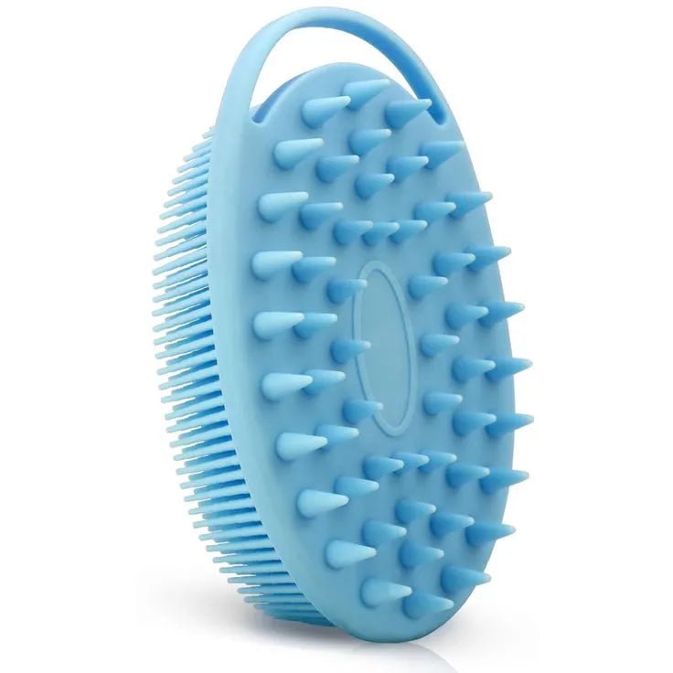 A blue silicone scrubbing brush with textured surface on a white background